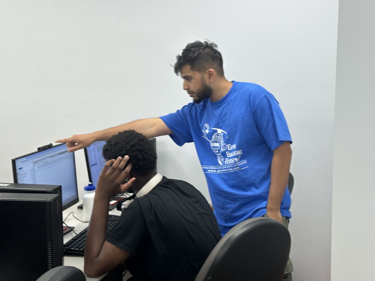 Nasif helping a student one-on-one at a computer